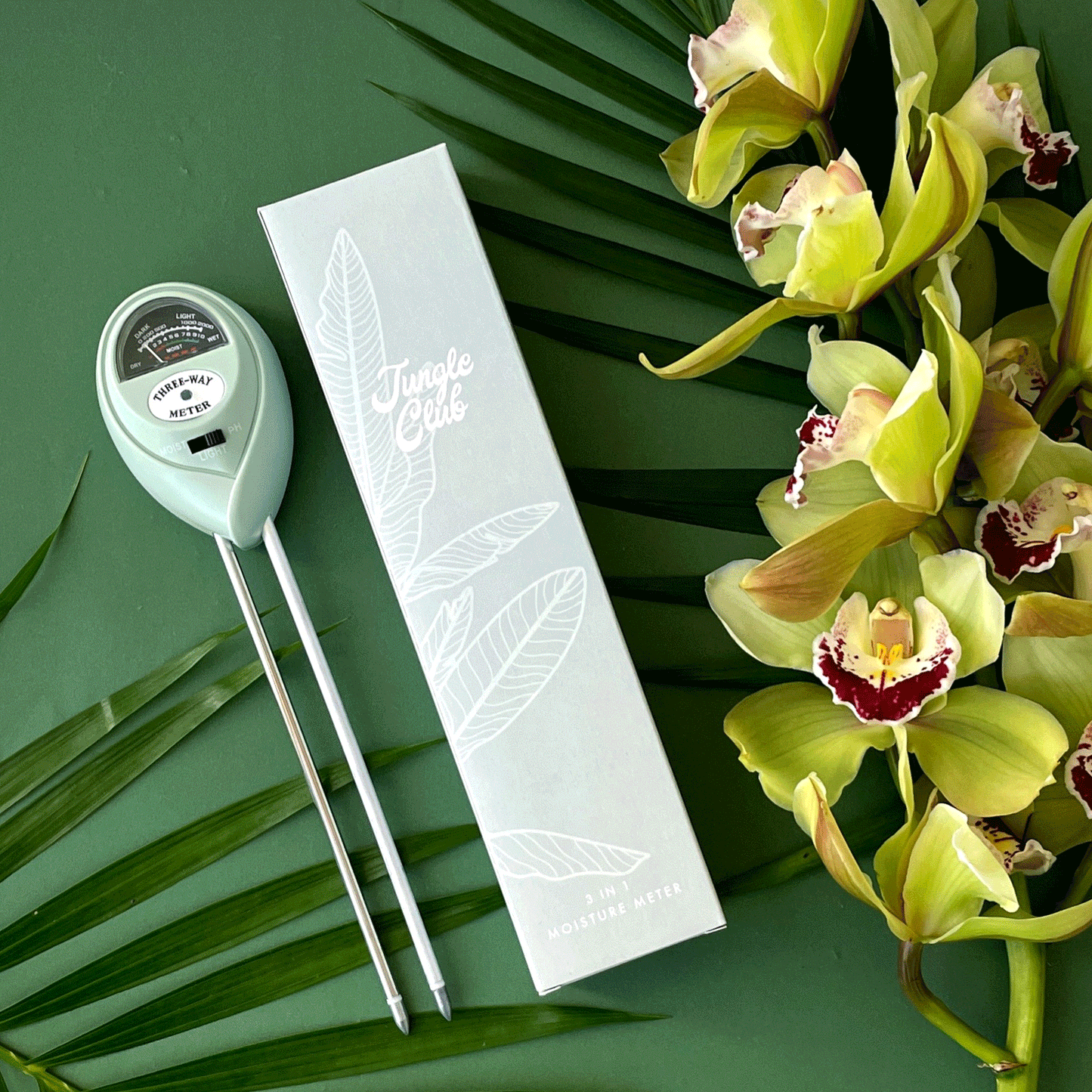 A light blue moisture meter with a circular head and a meter with a black background and text in the center that reads, "Three-way Meter" in black writing.