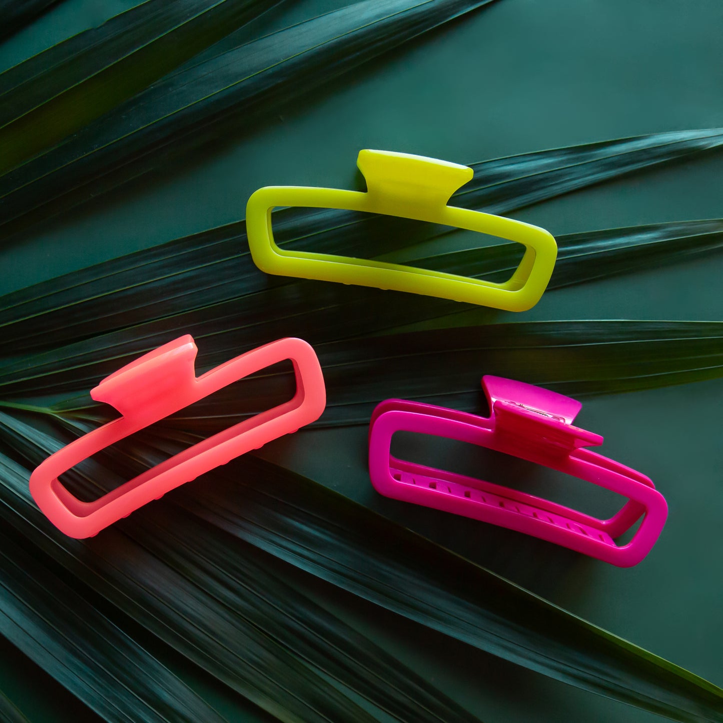 Three clips in hot pink, fuchsia and lime green.