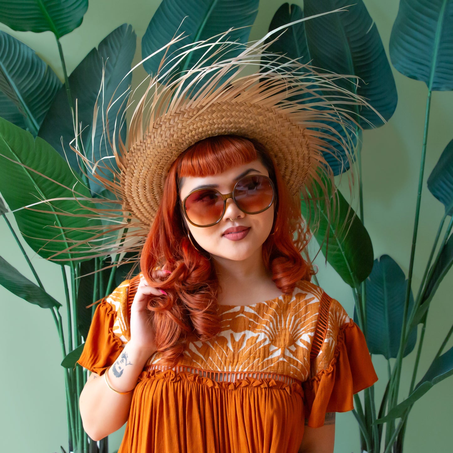 A cognac tortoise shaped round pair of sunglasses.