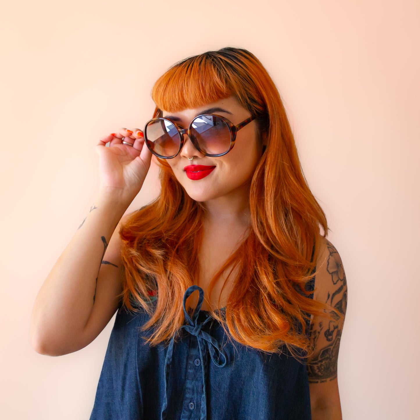 A cognac tortoise shaped round pair of sunglasses.