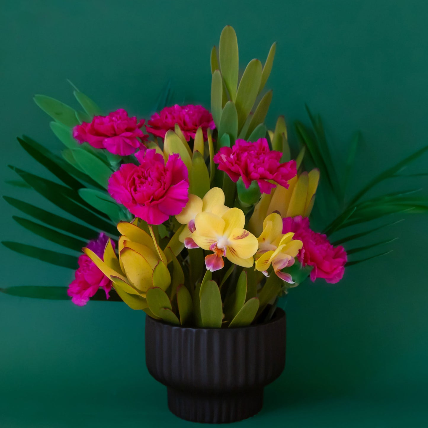 A ribbed black pedestal bowl planter.
