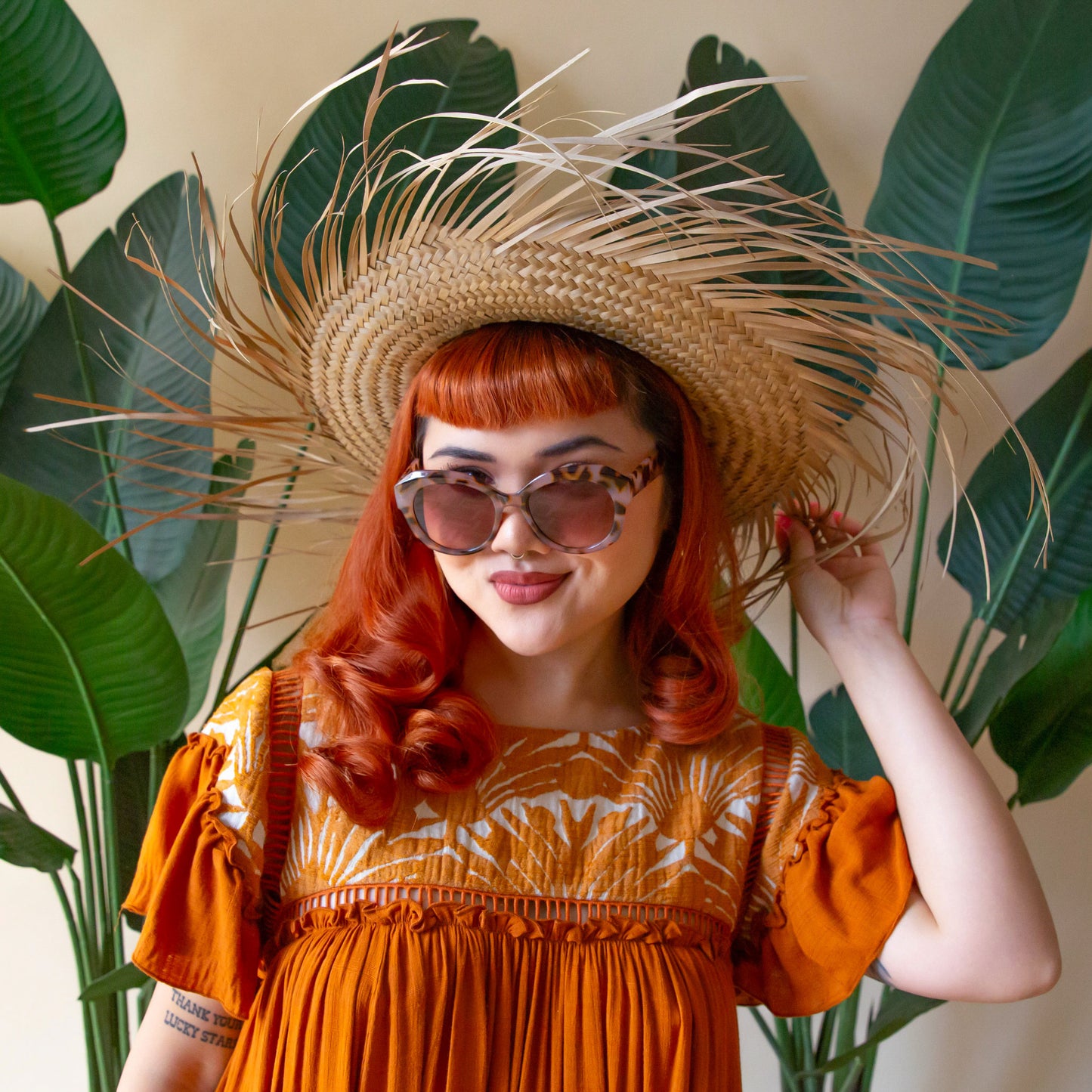 A brown and black pair of rounded oversized sunglasses.