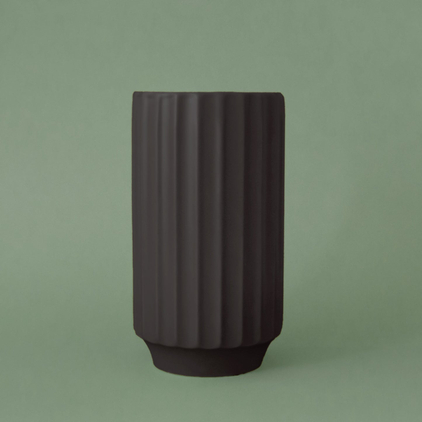 Ribbed ceramic vase in a matte black finish.