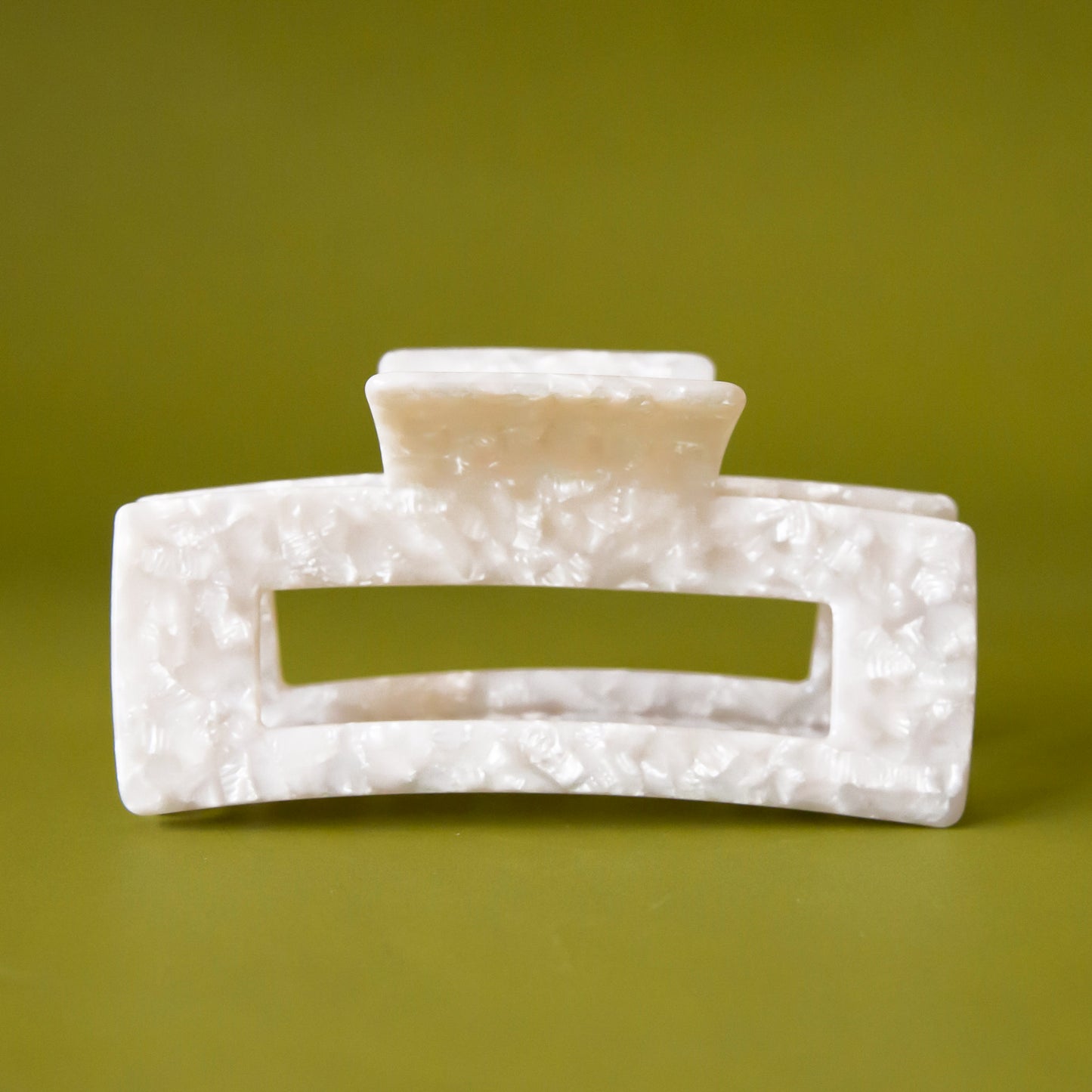 A pearly white rectangle claw clip.