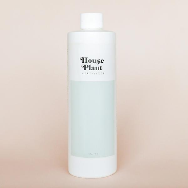 White bottle of House Plant fertilizer with a light blue label.