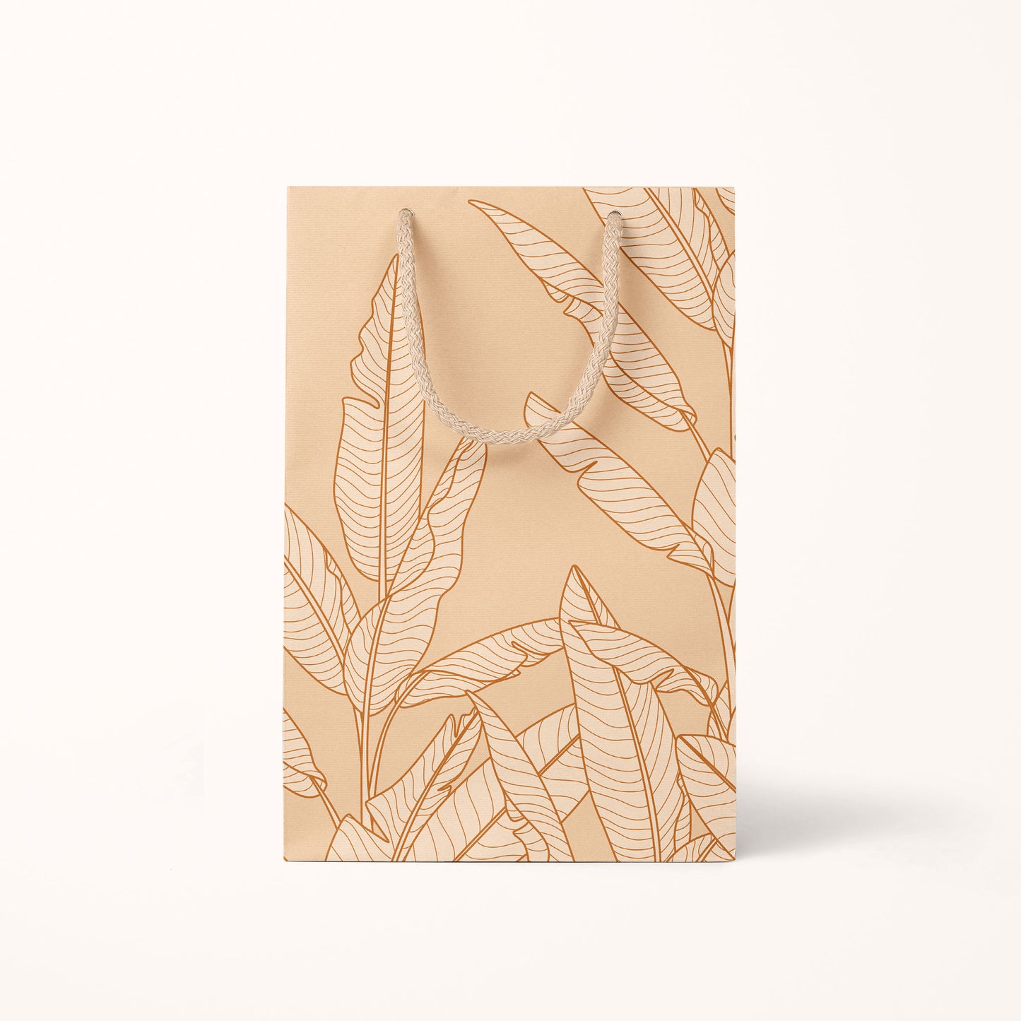 The smaller size of the gift bag that features cream cotton handles and super light shade of salmon pink with graphics of banana leaves.