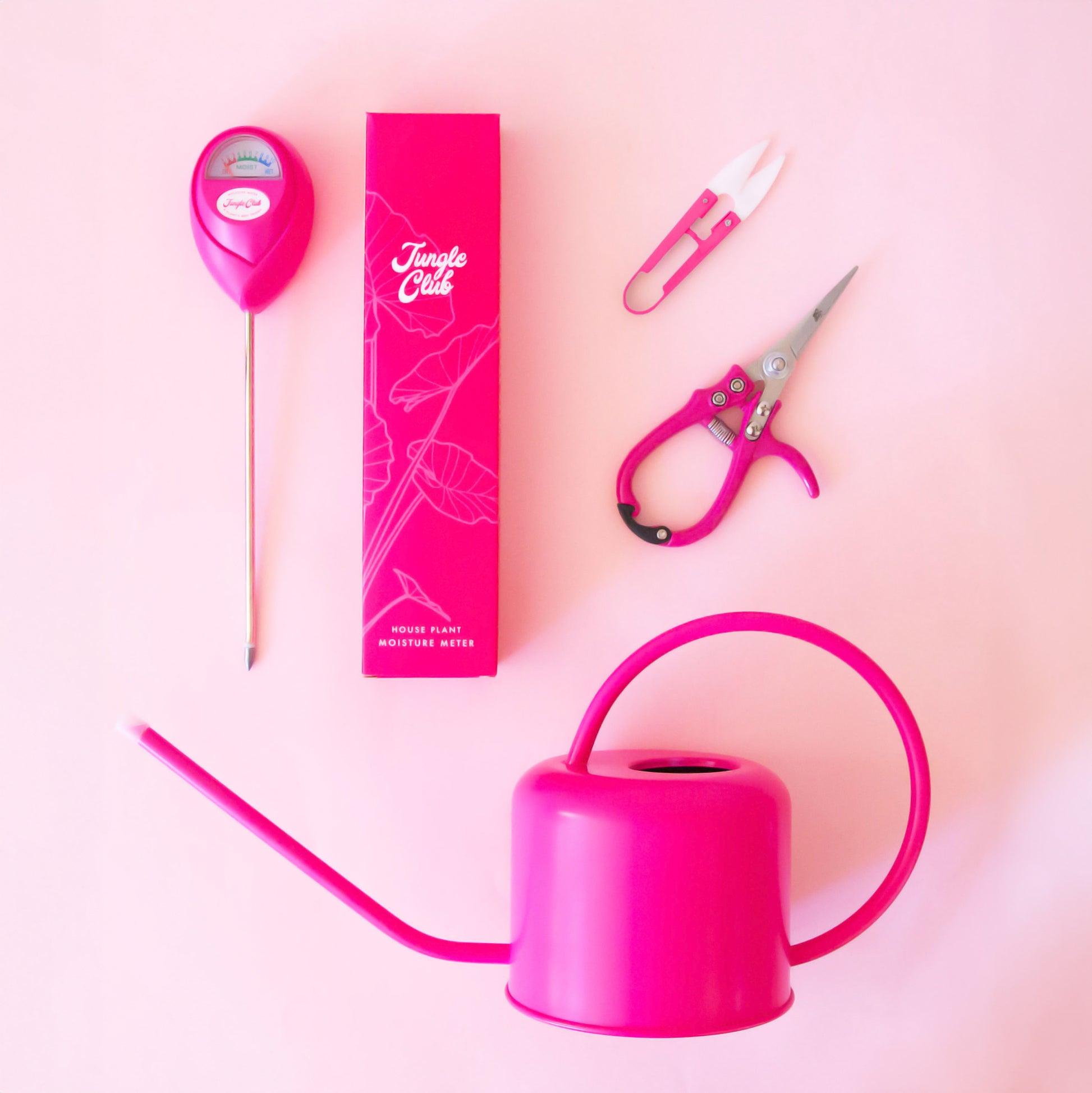 A photo of our hot pink hibiscus colored Jungle Club tools all sitting next to each other in a flat lay photo.