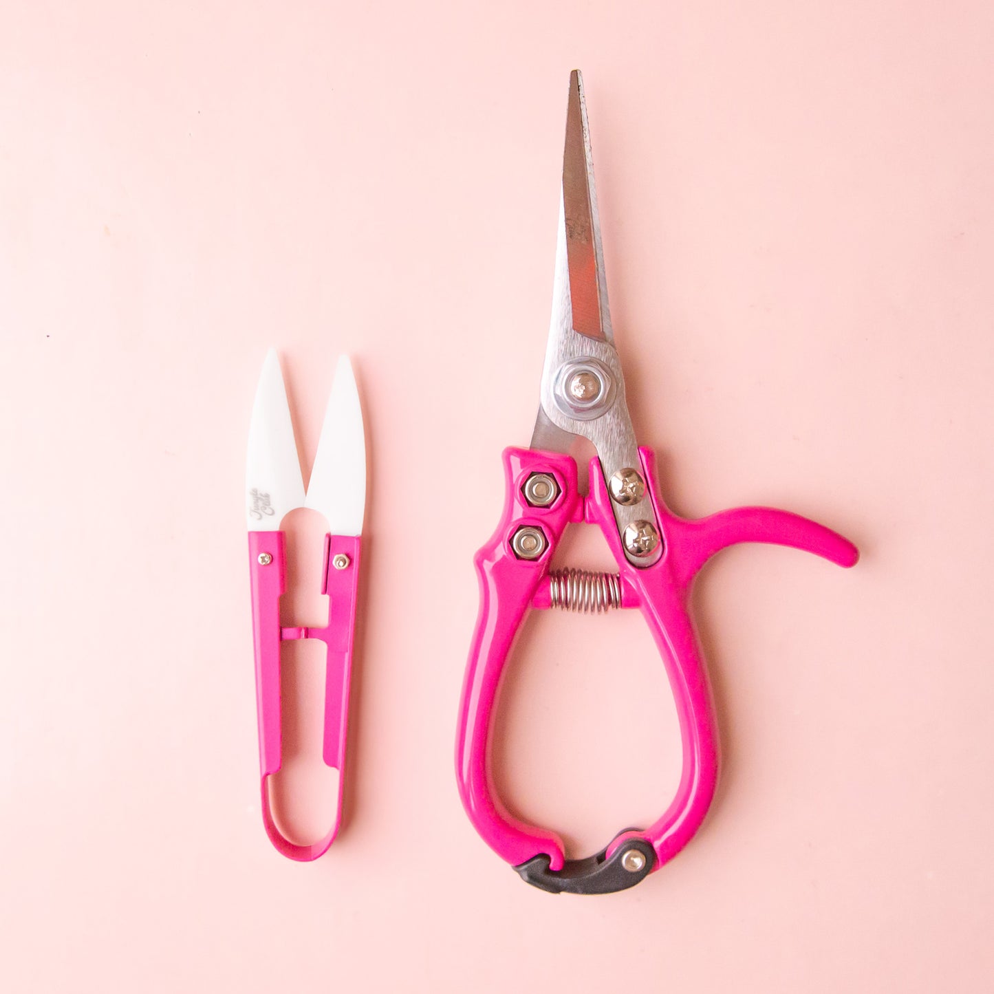 A set of pink pruning shears and mini plant snips. 