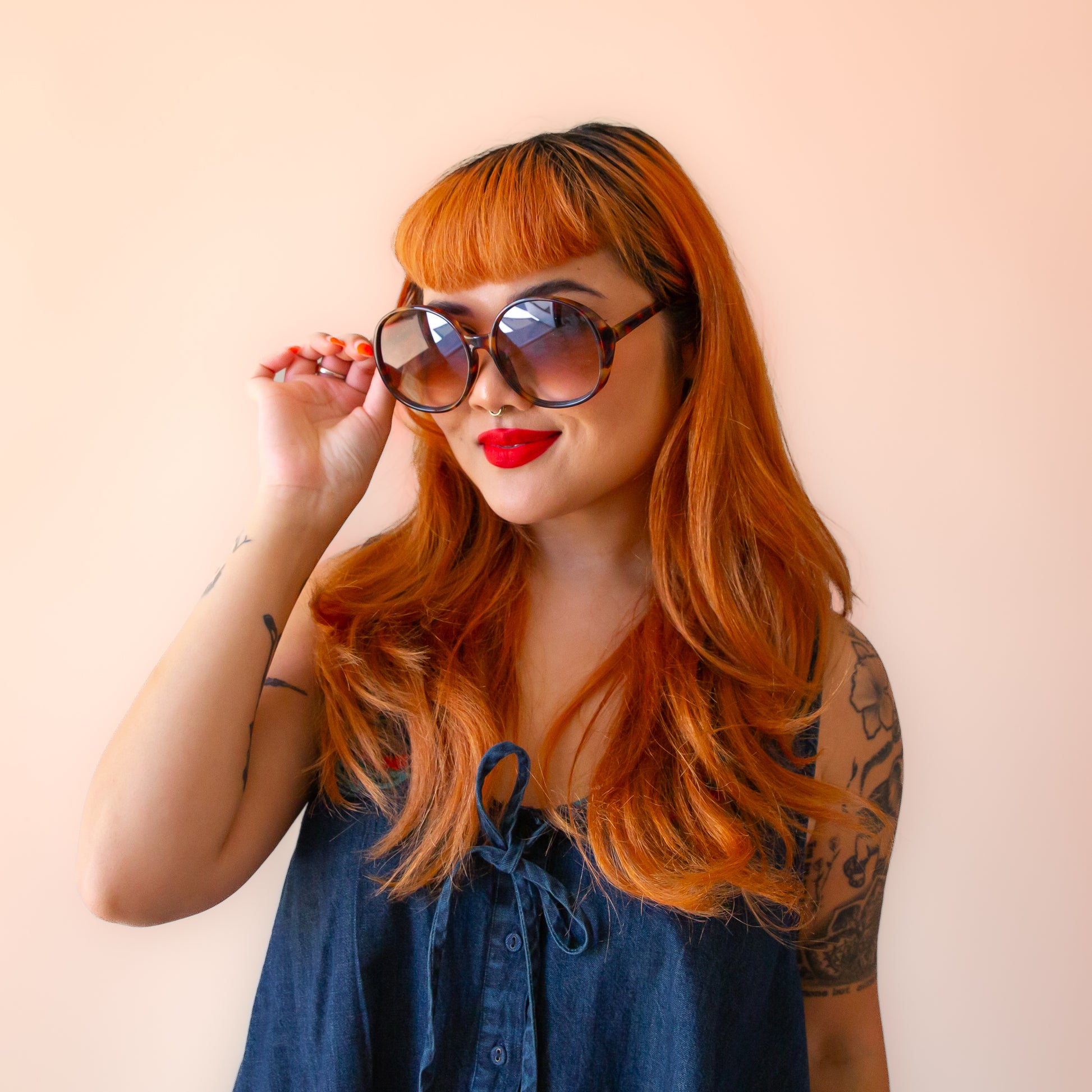 A cognac tortoise shaped round pair of sunglasses. 