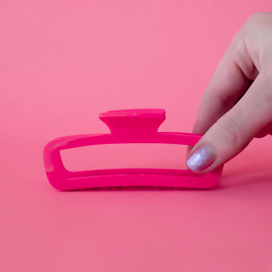 A hot pink rectangle claw clip with rounded edges. 