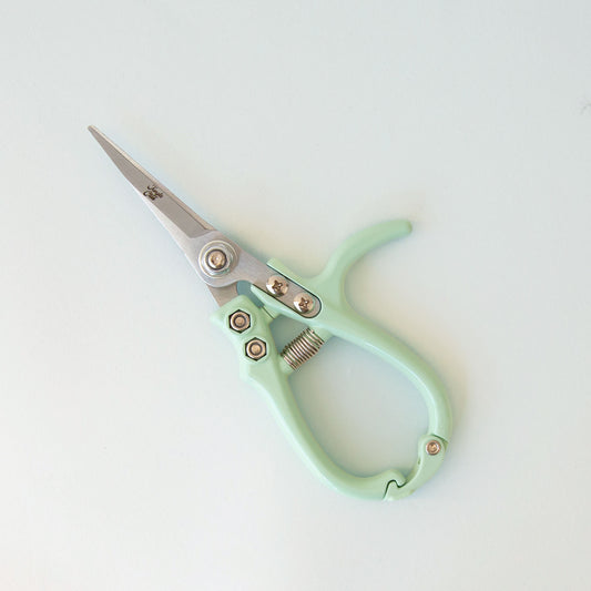 A pair of mint green planting shears.