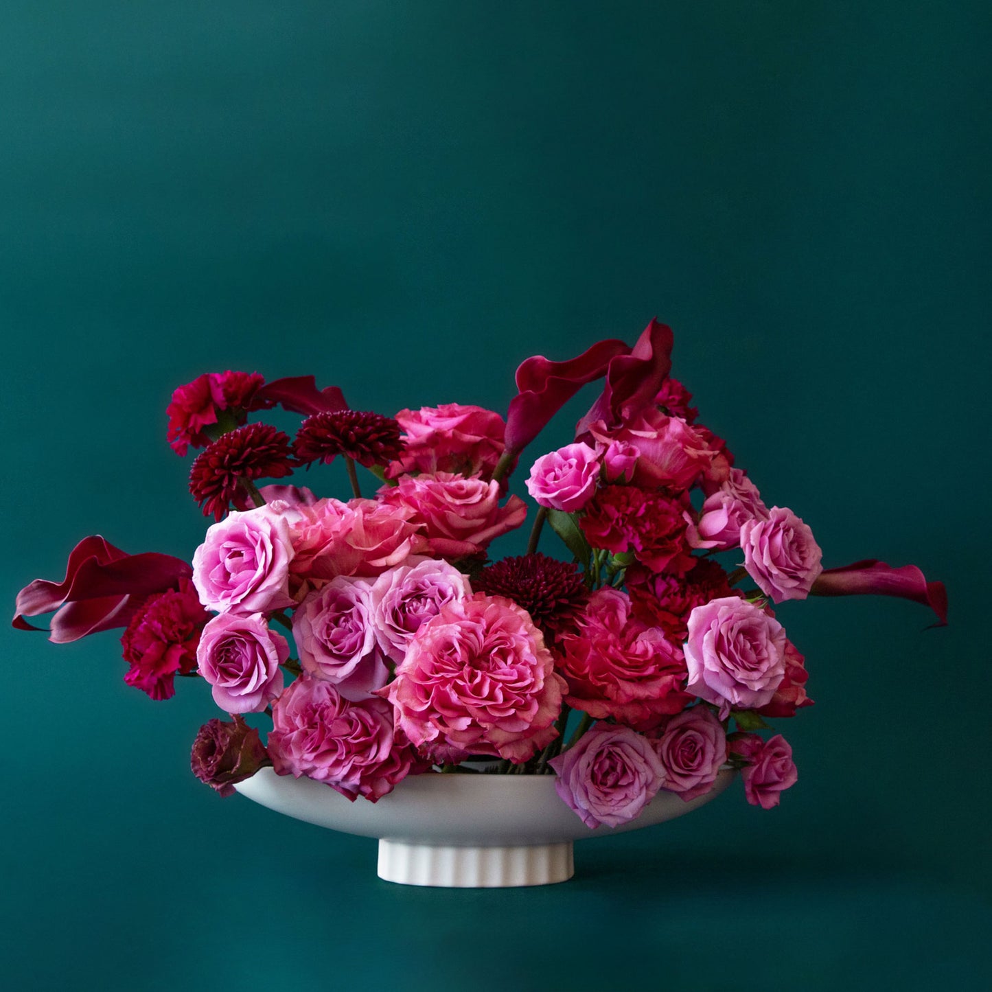 An elongated ceramic pedestal bowl 