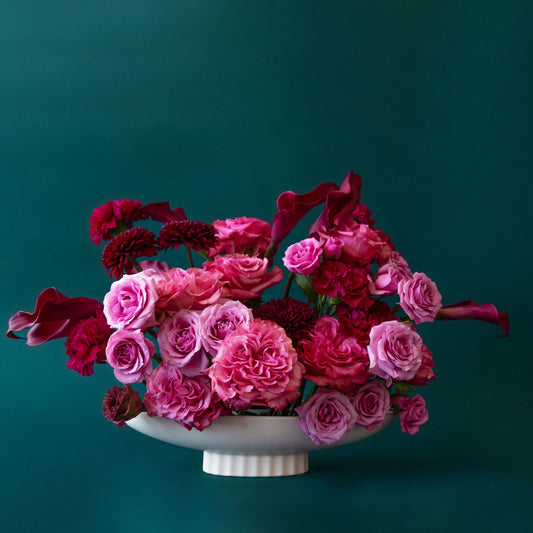 An elongated ceramic pedestal bowl 