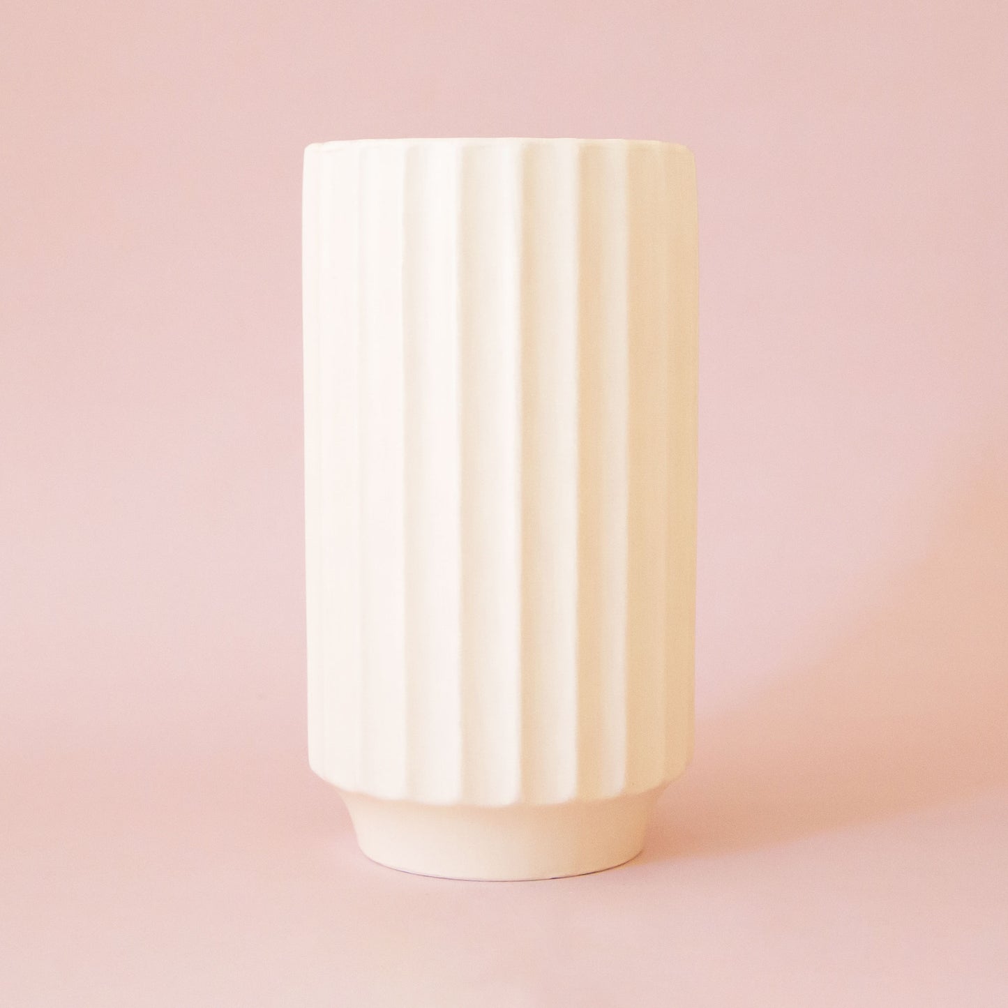 An ivory ceramic fluted vase. 