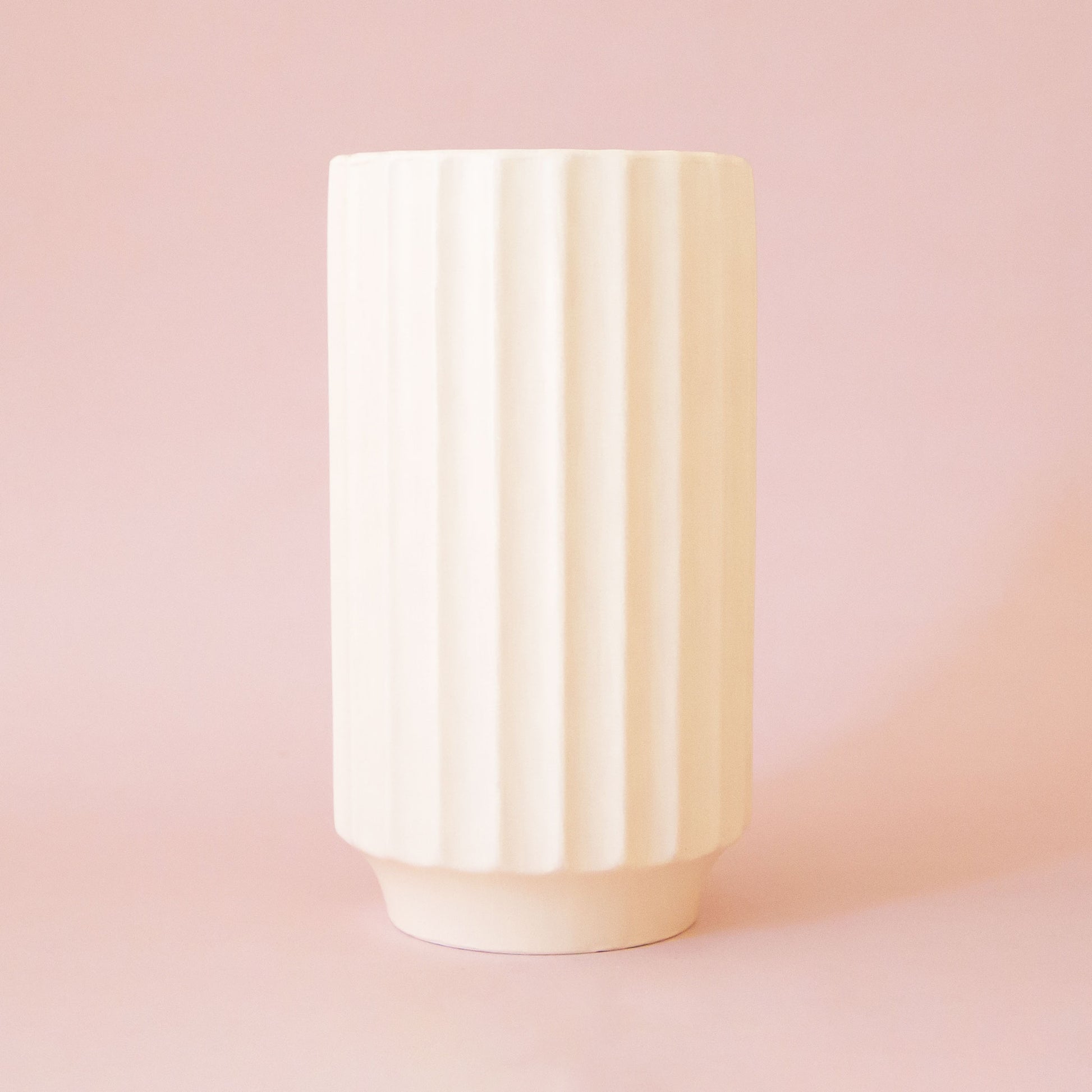 An ivory ceramic fluted vase. 