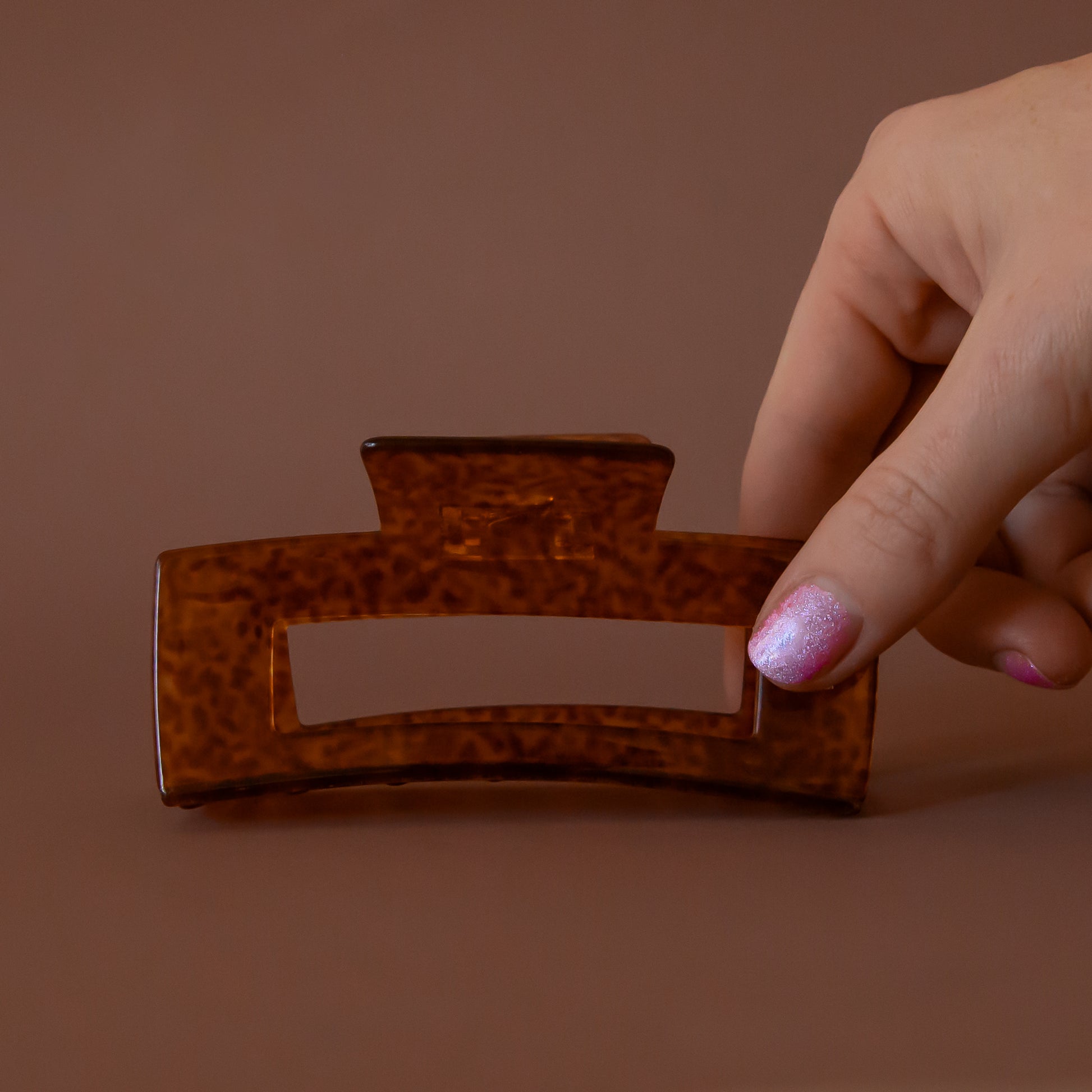 A brown animal print rectangle claw clip. 