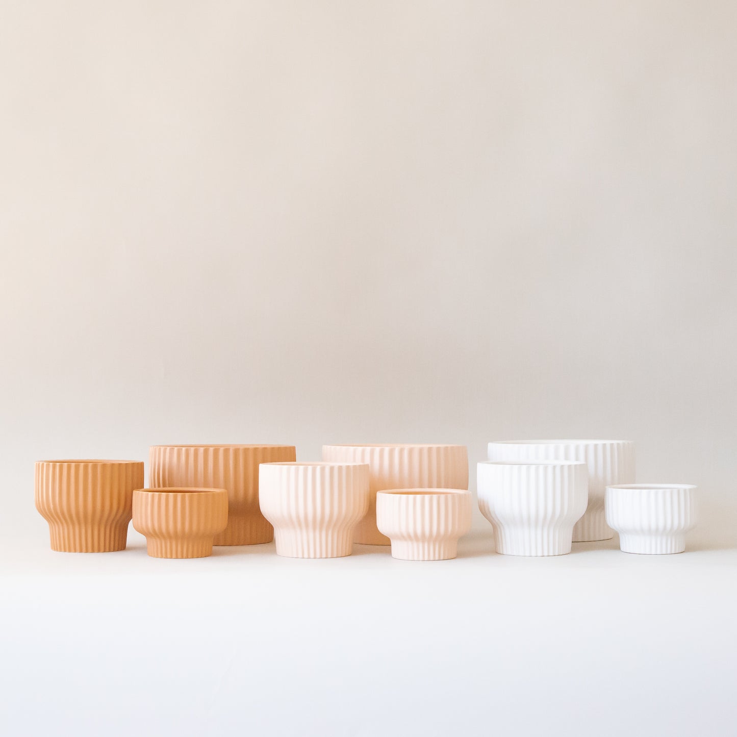 The latte presley bowls next to two other color ways in light pink shade and white. 