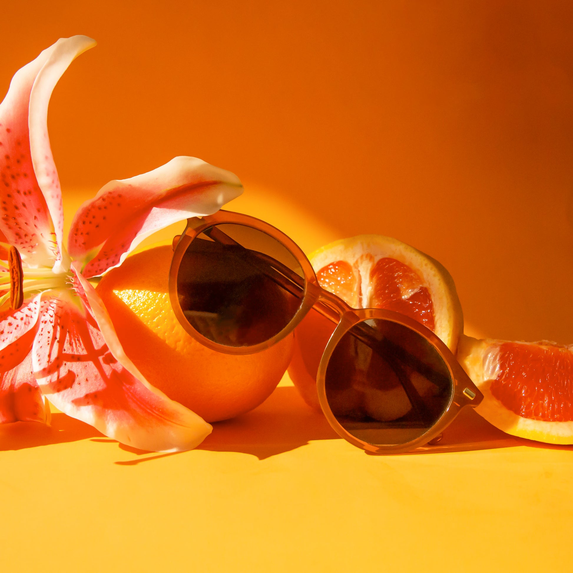 A pair of round orange sunglasses. 