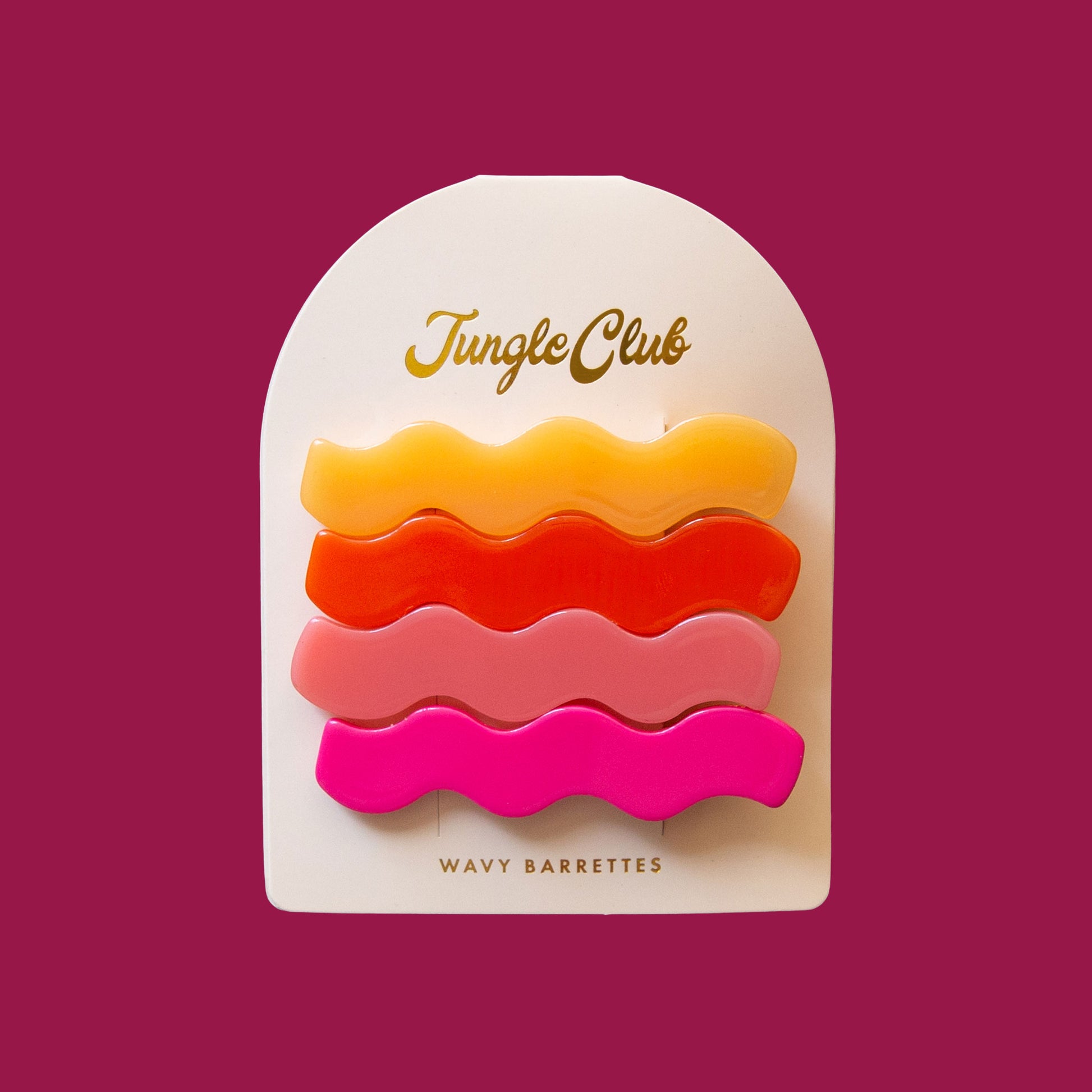Pack of wavy hair barrettes. Each clip is a different color: Hot Pink, Light Pink, Red, and Yellow. The 4 clips are on card stock. 