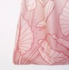 A light pink reusable tote bag made of nylon and detailed with line drawings of alocasia leaves.