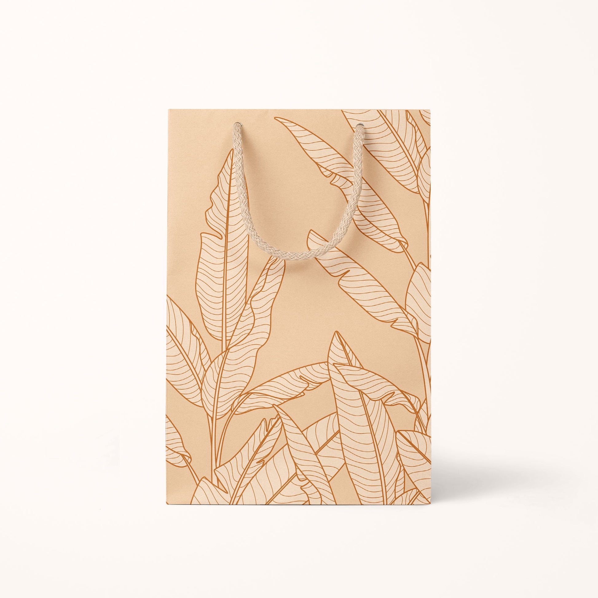 The smaller size of the gift bag that features cream cotton handles and super light shade of salmon pink with graphics of banana leaves.