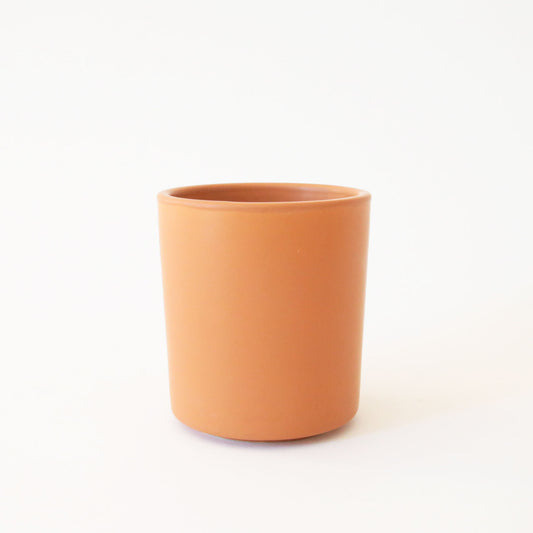 A pumpkin spice orange ceramic vase perfect for a succulent arrangement or a small plant.