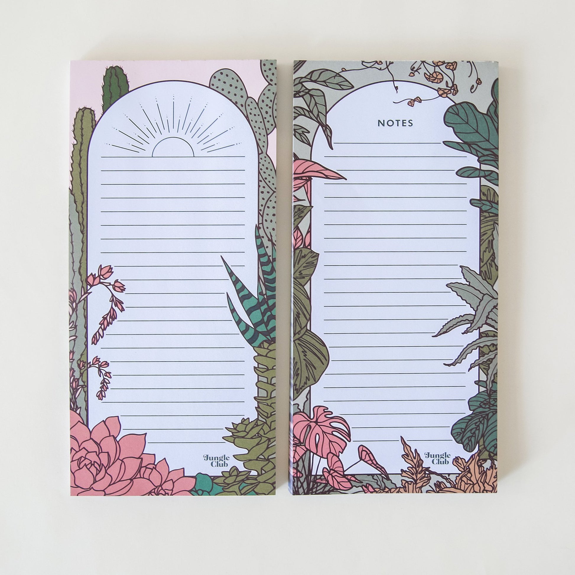 Two rectangular notepads filled with horizontal lines and outlined in a deep green borders, accented by an array of natural, soft toned jungle plants. The notepad to the left features a simple sunset horizon print and the other is titled 'Notes' above.