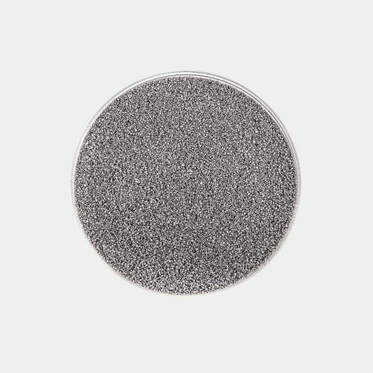 On a light gray background is a bowl of gray terrarium sand.  